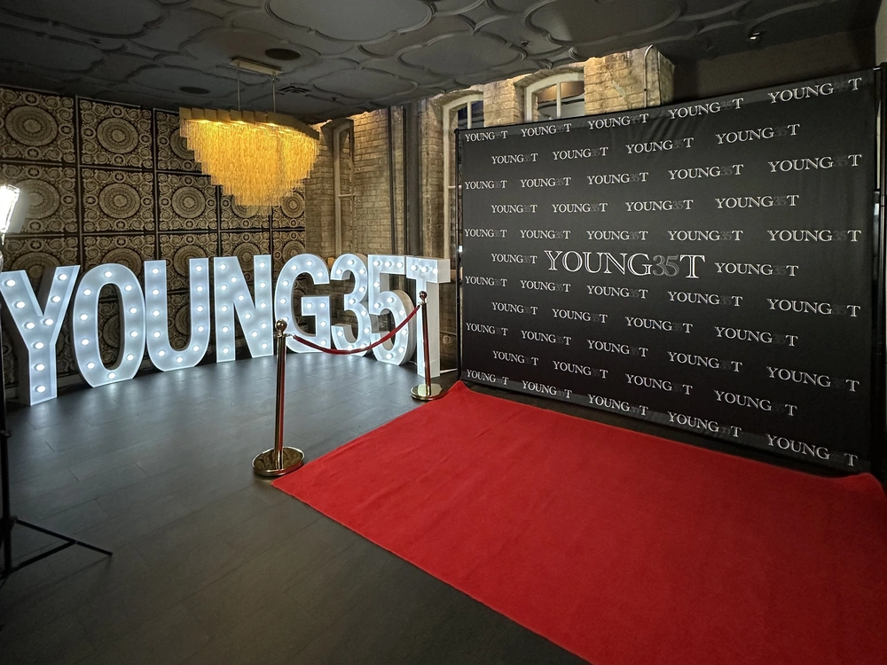 Custom brand activation setup with a red carpet, custom sign and custom backdrop: brand activation photo booth rental in Brampton