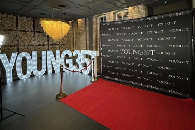 Light-up marquee letters, a red carpet and a branded step-and-repeat backdrop at a corporate event: brand activation photo booth rental in Burlington