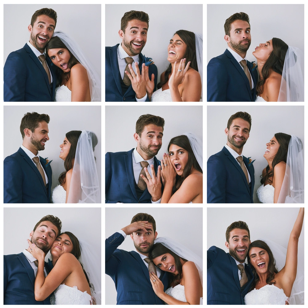 Couple posing in print offs from a wedding photobooth: wedding photo booth rental in Burlington