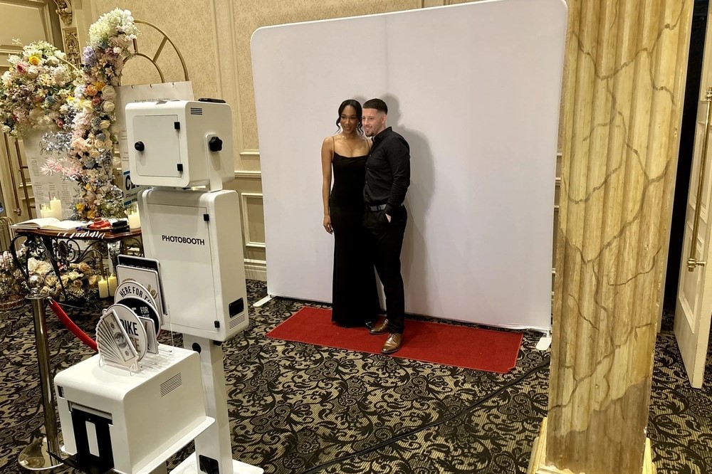 Couple posing for a wedding photo booth: wedding photo booth rental in Oakville