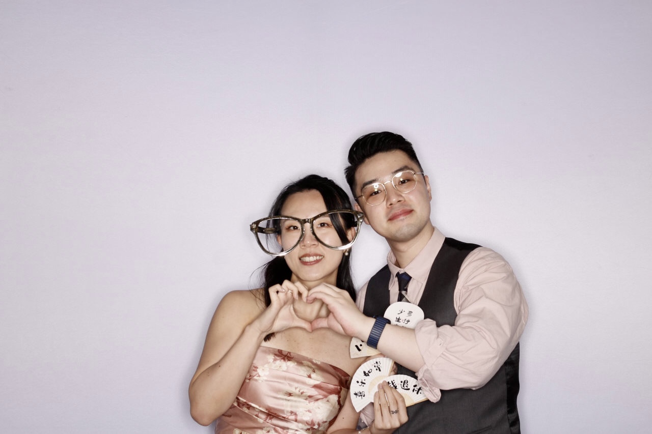 Couple posing for a glam photo booth in colour
