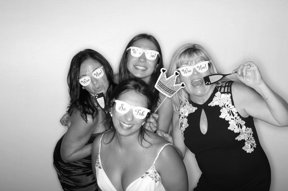 Group posing for wedding photo booth pictures
